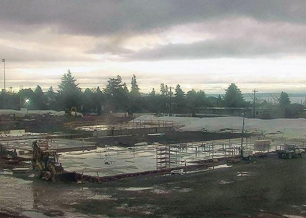 aerial view of a construction site that is still mostly flat and has some equipment on it