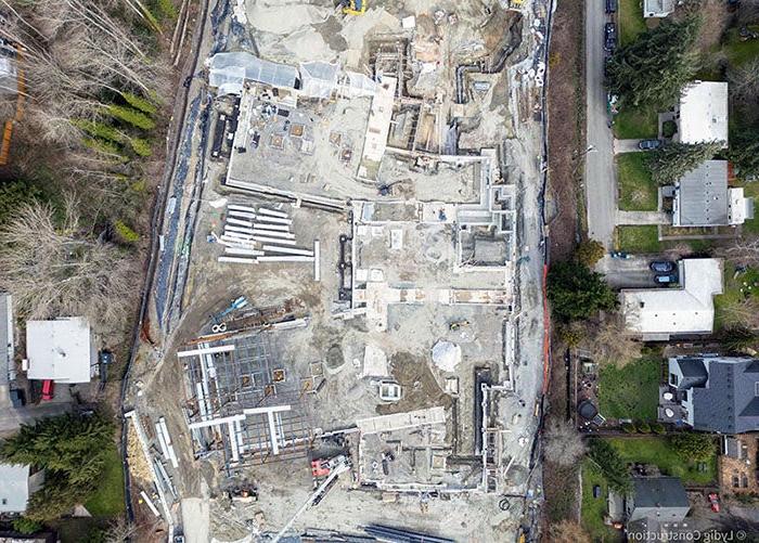 aerial of part of a construction site with foundations outlining the building footprint and some structural steel erected