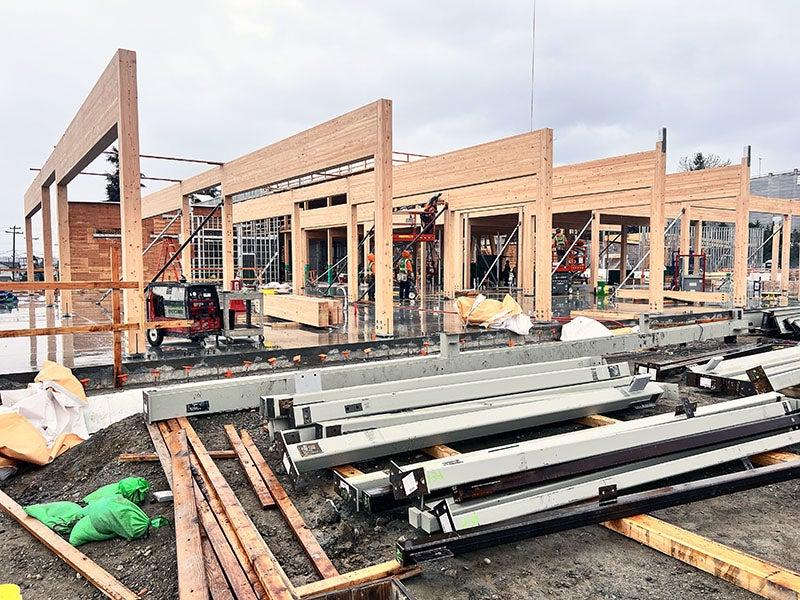 a row of frames made of columns and beams with steel on the ground in front