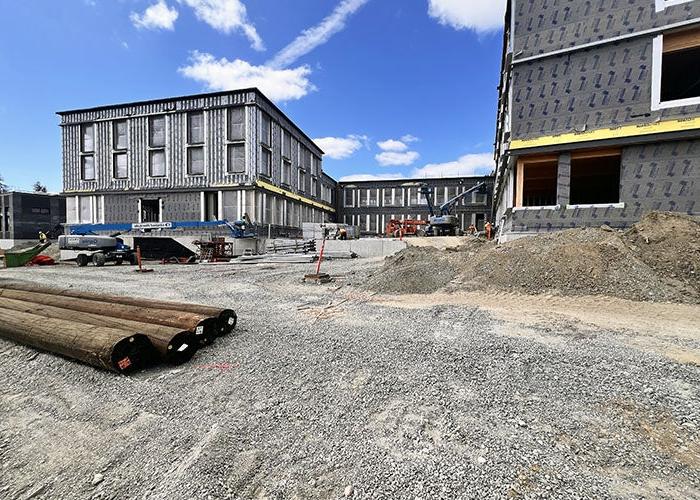 a building under construction with gray material on the exterior walls