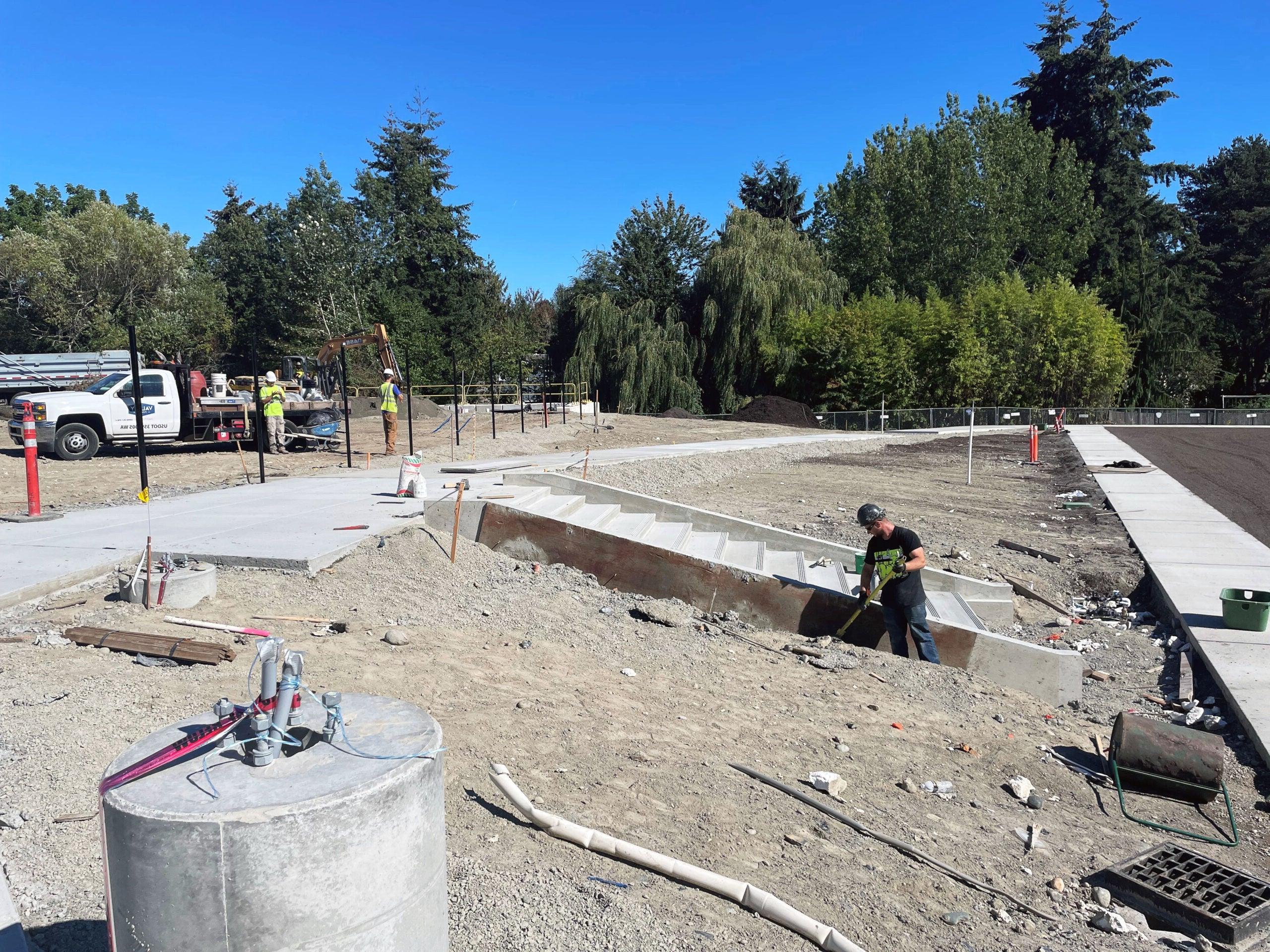 a person working with a shovel next to concrete stairs