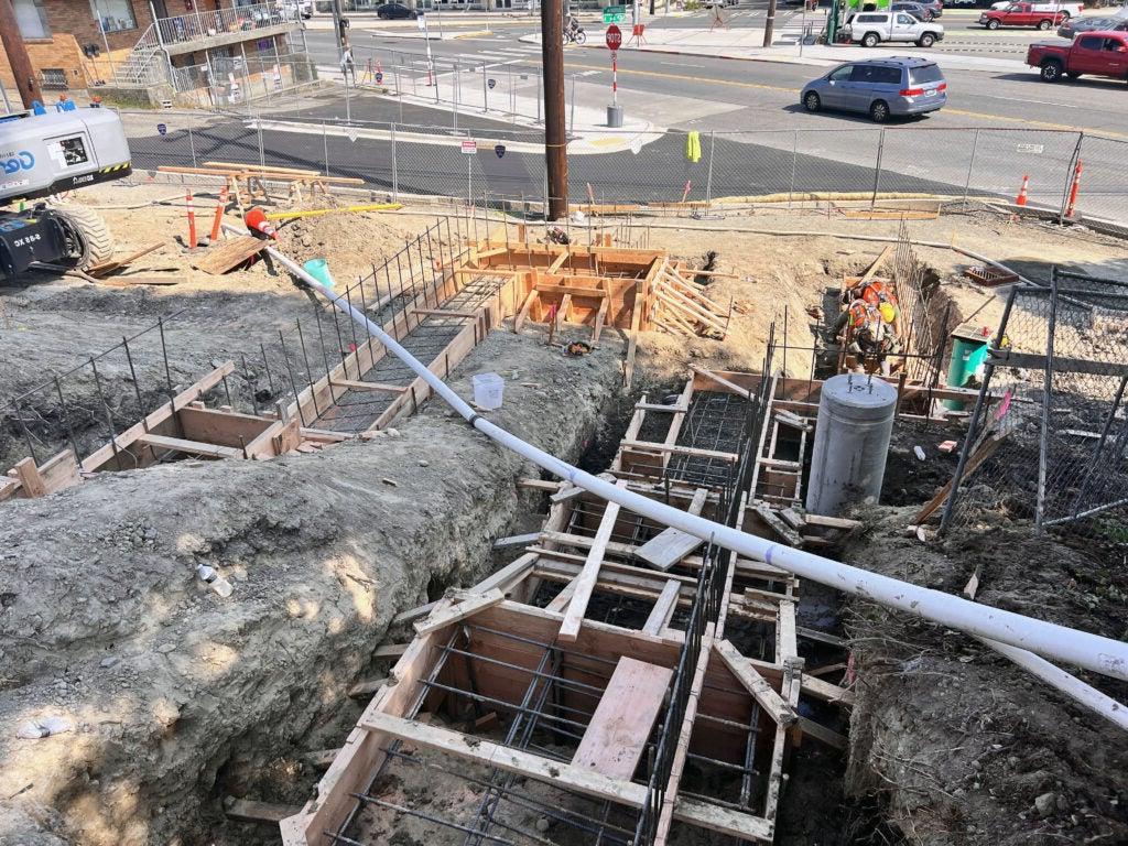 looking down a hill that has wood forms with rebar ready for concrete