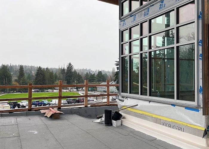 a patio under cover outside of large windows