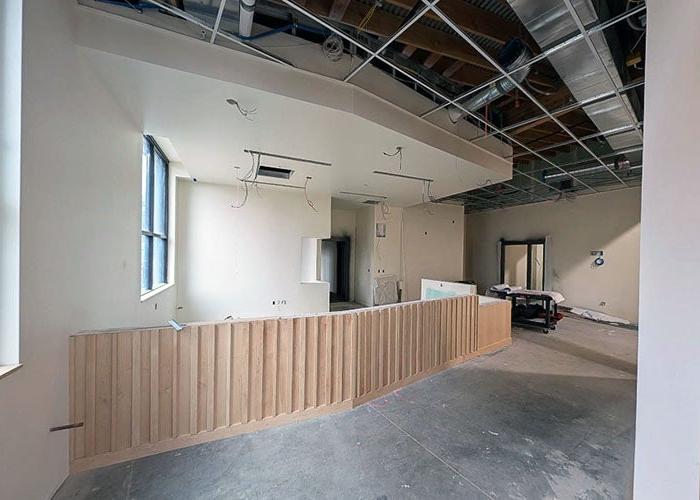 a room under construction with a curved slatted based for a desk