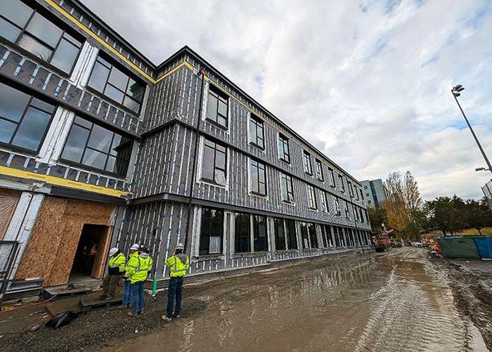 building under construction with three floors of windows